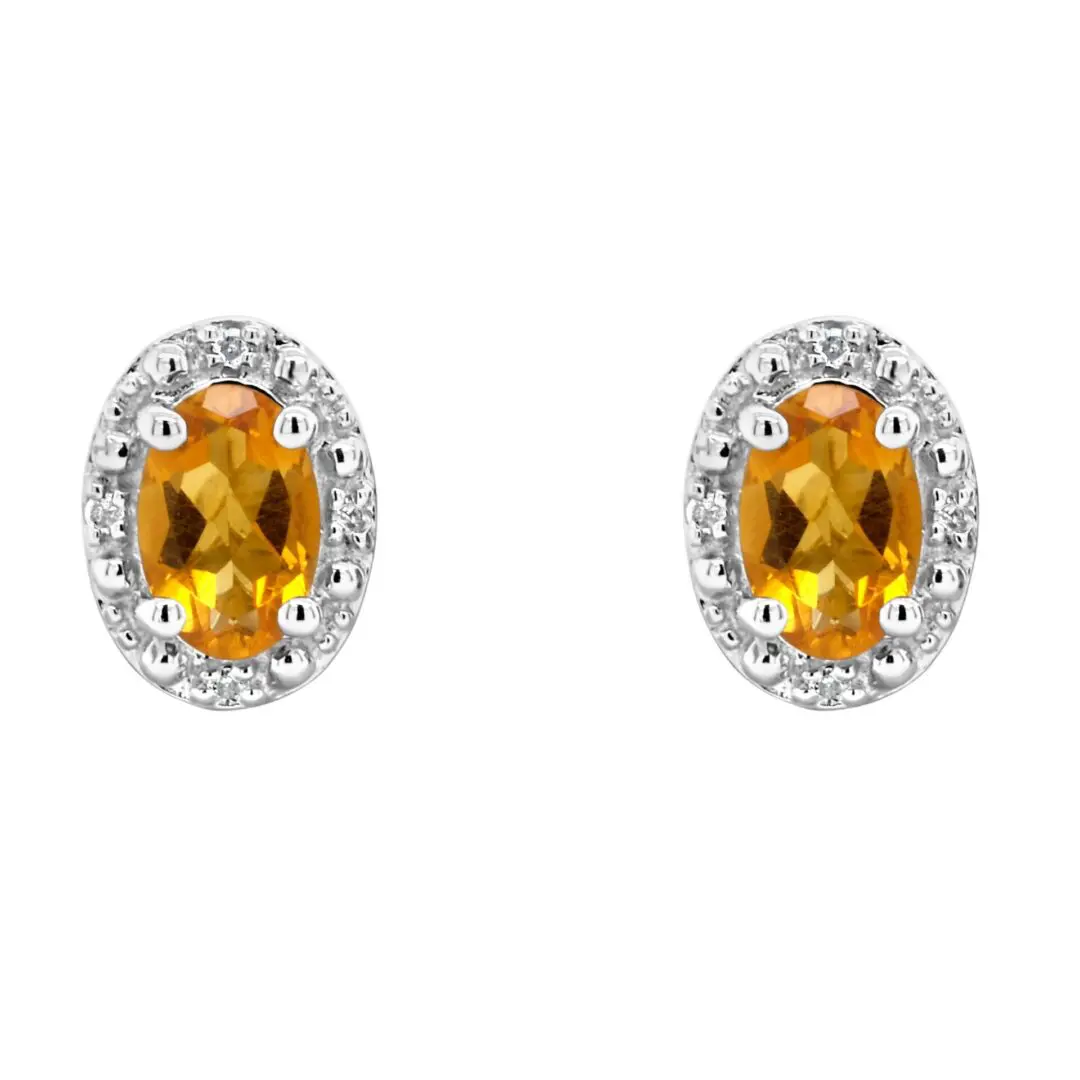 A pair of earrings with diamonds and an oval cut stone.