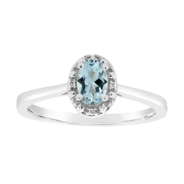 A white gold ring with an oval cut aquamarine and diamond halo.