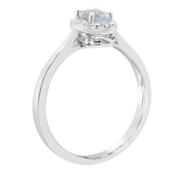 A white gold ring with a diamond on top of it.