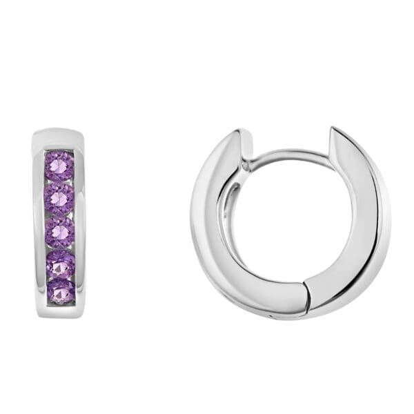 A pair of silver earrings with purple stones.